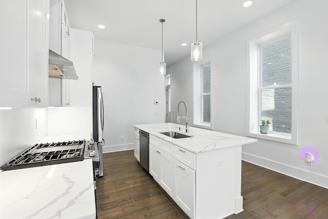 310 W Robbins St, Covington, KY 41011 - kitchen featuring extractor fan, appliances with stainless steel finishes, dark wood finished floors, white cabinetry, and a center island with sink