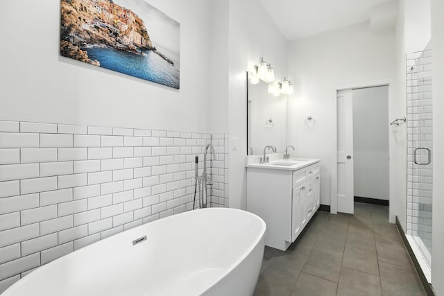 310 W Robbins St, Covington, KY 41011 - bathroom with vanity, a soaking tub, tile patterned flooring, tile walls, and a shower stall