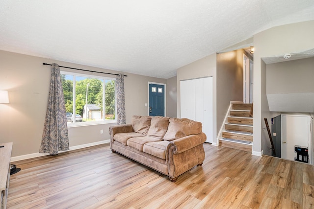 30 Valeside Dr, Covington, KY 41017 - living area featuring lofted ceiling, light wood-type flooring, stairway, and a textured ceiling