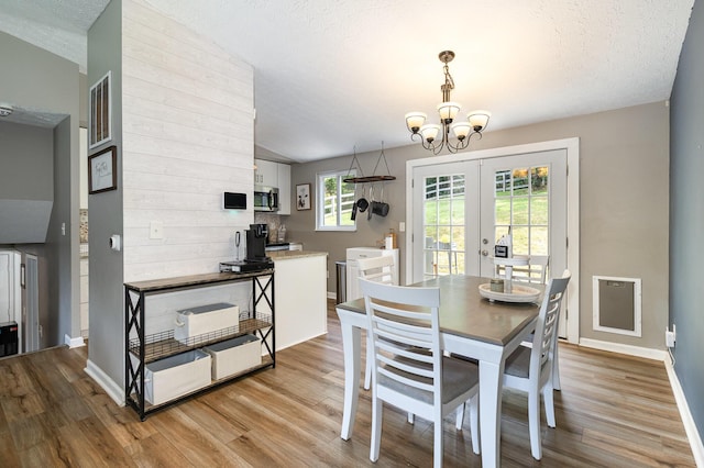 30 Valeside Dr, Covington, KY 41017 - dining room with a chandelier, light wood-style floors, french doors, and a textured ceiling