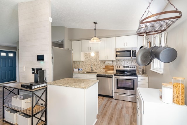 30 Valeside Dr, Covington, KY 41017 - kitchen featuring stainless steel appliances, vaulted ceiling, light wood-style floors, white cabinetry, and backsplash