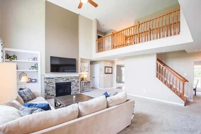 800 Buck Ct, Erlanger, KY 41018 - living area with a ceiling fan, stairway, a high ceiling, carpet, and a stone fireplace