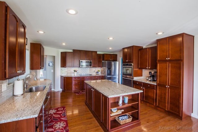 800 Buck Ct, Erlanger, KY 41018 - kitchen featuring stainless steel appliances, decorative backsplash, a kitchen island, wood finished floors, and recessed lighting