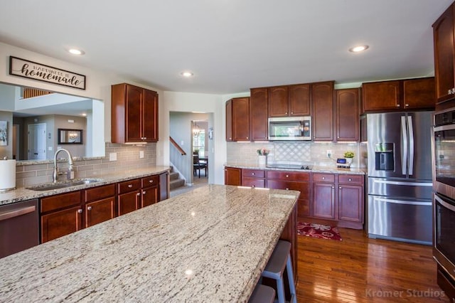 800 Buck Ct, Erlanger, KY 41018 - kitchen with stainless steel appliances, tasteful backsplash, light stone counters, dark wood finished floors, and recessed lighting
