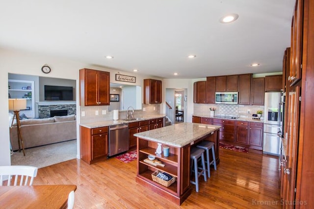 800 Buck Ct, Erlanger, KY 41018 - kitchen with stainless steel appliances, a kitchen island, decorative backsplash, open shelves, and light wood finished floors