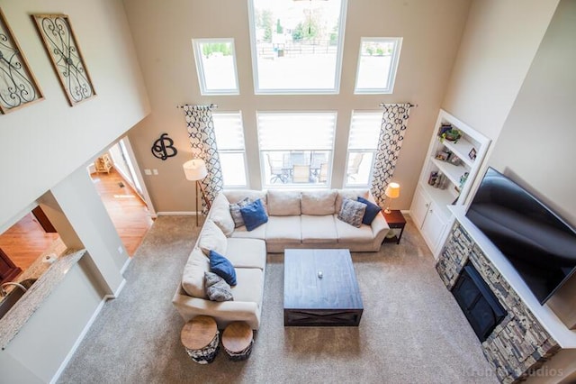800 Buck Ct, Erlanger, KY 41018 - living area with a towering ceiling, carpet flooring, and a stone fireplace