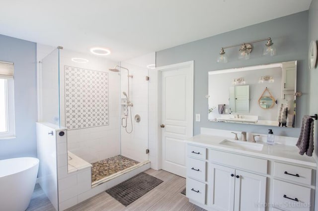 800 Buck Ct, Erlanger, KY 41018 - bathroom with a shower stall, a freestanding bath, vanity, and wood finished floors