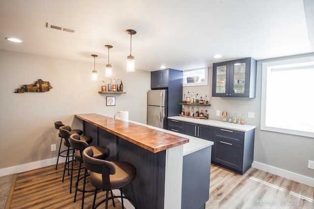 800 Buck Ct, Erlanger, KY 41018 - indoor wet bar with freestanding refrigerator, light wood-style flooring, recessed lighting, and decorative light fixtures