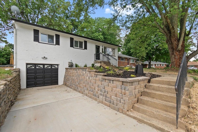695 Maple Tree Ln, Erlanger, KY 41018 - view of front of home featuring a garage, brick siding, and concrete driveway