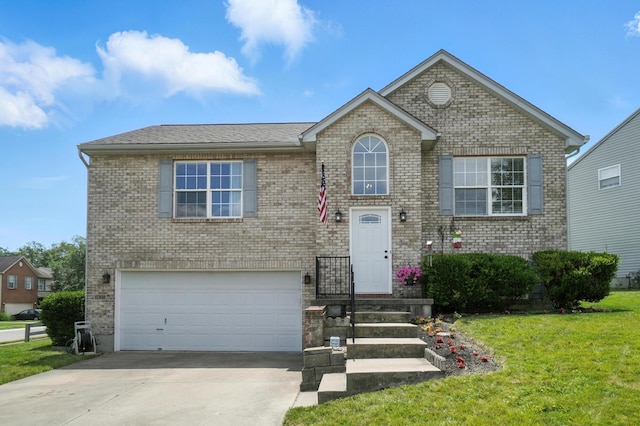 1625 Hogan Ln, Florence, KY 41042 - view of front of house featuring an attached garage, driveway, a front yard, and brick siding