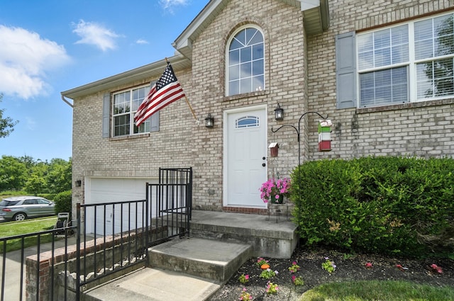 1625 Hogan Ln, Florence, KY 41042 - entrance to property featuring an attached garage, brick siding, and concrete driveway