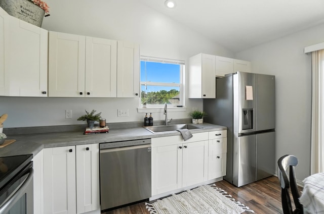 1625 Hogan Ln, Florence, KY 41042 - kitchen with appliances with stainless steel finishes, vaulted ceiling, white cabinetry, dark wood-style floors, and recessed lighting