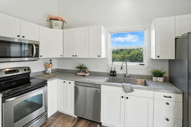 1625 Hogan Ln, Florence, KY 41042 - kitchen with appliances with stainless steel finishes, white cabinetry, and dark wood finished floors