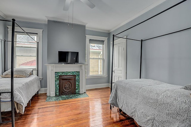 3141 Beech Ave, Covington, KY 41015 - bedroom with crown molding, light wood-style flooring, multiple windows, a fireplace, and a ceiling fan