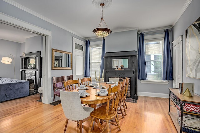 3141 Beech Ave, Covington, KY 41015 - dining space with a brick fireplace, light wood finished floors, and crown molding
