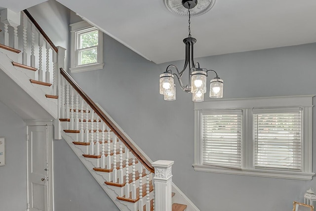 3141 Beech Ave, Covington, KY 41015 - staircase featuring vaulted ceiling and a chandelier