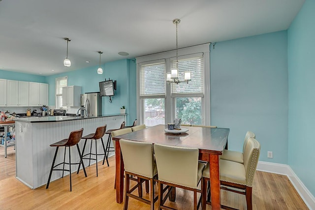 3141 Beech Ave, Covington, KY 41015 - dining space featuring light wood-type flooring and a chandelier