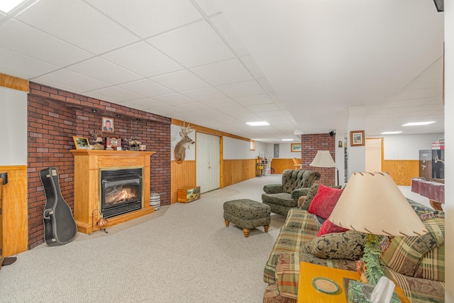 3950 Elliston Mount Zion Rd, Dry Ridge, KY 41035 - living area featuring wood walls, wainscoting, carpet flooring, a brick fireplace, and a drop ceiling
