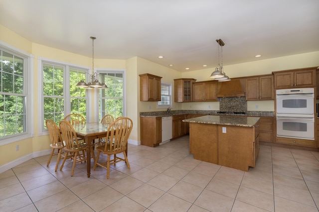 405 Alexander Rd, Crittenden, KY 41030 - kitchen featuring white appliances, custom exhaust hood, brown cabinetry, a kitchen island, and light tile patterned flooring