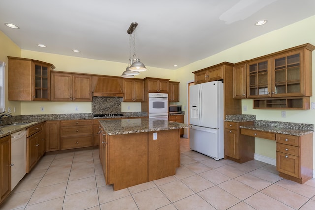 405 Alexander Rd, Crittenden, KY 41030 - kitchen featuring white appliances, premium range hood, a kitchen island, brown cabinets, and light tile patterned flooring