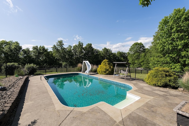 405 Alexander Rd, Crittenden, KY 41030 - view of swimming pool featuring a water slide, a fenced backyard, a patio area, and view of scattered trees
