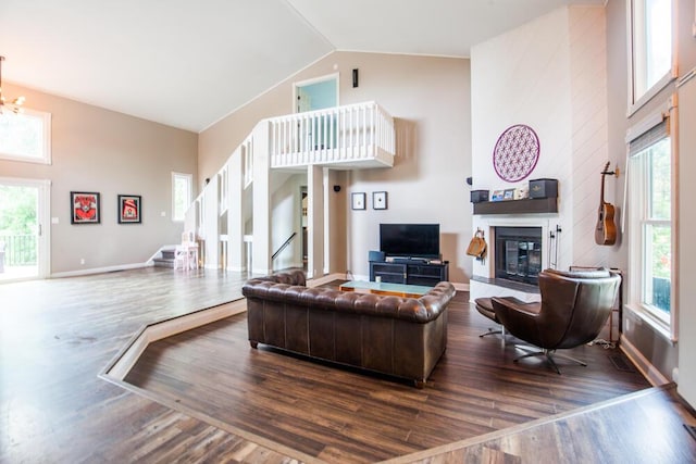 108 Regency Ct, Highland Heights, KY 41076 - living room with wood finished floors, a fireplace, healthy amount of natural light, high vaulted ceiling, and stairs