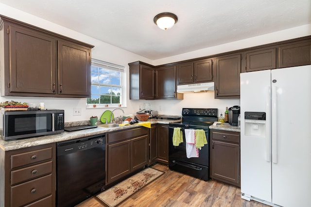 1539 Raintree Ct, Elsmere, KY 41018 - kitchen featuring black appliances, under cabinet range hood, dark brown cabinets, light countertops, and light wood-style flooring