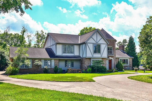 423 Burr Oak Ct, Edgewood, KY 41017 - tudor house with a front yard, board and batten siding, and brick siding