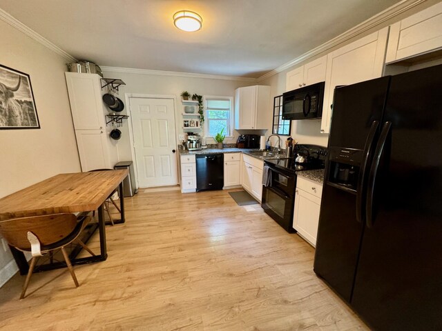 2543 Enid Ave, Crescent Springs, KY 41017 - kitchen featuring black appliances, dark countertops, white cabinets, crown molding, and light wood-style floors
