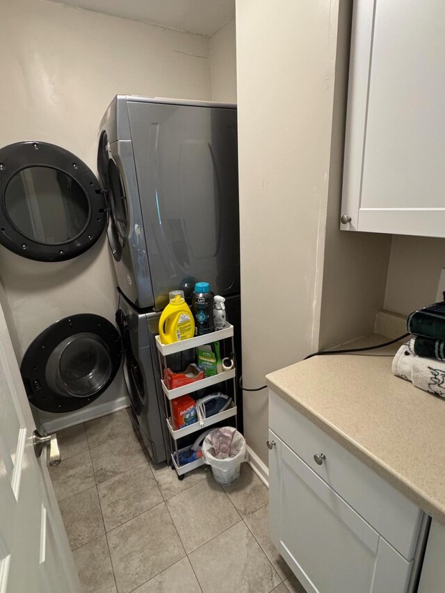 2543 Enid Ave, Crescent Springs, KY 41017 - washroom featuring stacked washer / drying machine, light tile patterned flooring, and cabinet space