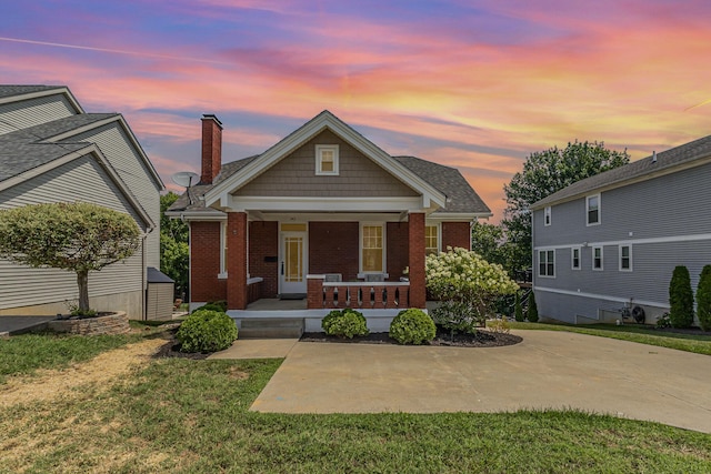 343 Rossford Ave, Fort Thomas, KY 41075 - view of front of home with a chimney, covered porch, brick siding, and a front yard