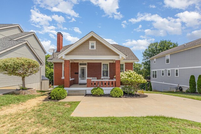 343 Rossford Ave, Fort Thomas, KY 41075 - view of front of home featuring brick siding, a front lawn, a porch, and a chimney