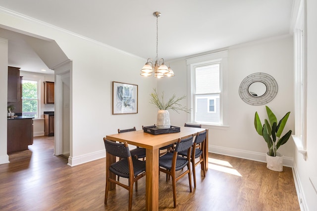 343 Rossford Ave, Fort Thomas, KY 41075 - dining area with dark wood-style floors, a chandelier, and ornamental molding