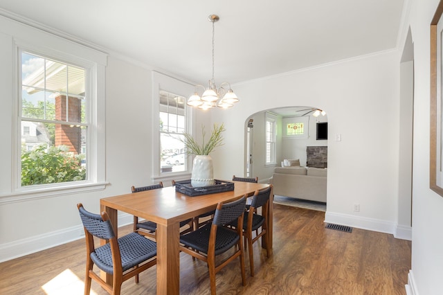 343 Rossford Ave, Fort Thomas, KY 41075 - dining area featuring arched walkways, dark wood-type flooring, a chandelier, and crown molding