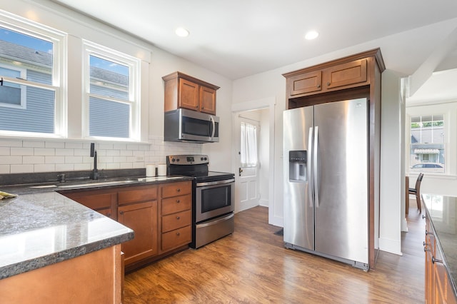 343 Rossford Ave, Fort Thomas, KY 41075 - kitchen featuring stainless steel appliances, brown cabinetry, decorative backsplash, wood finished floors, and recessed lighting
