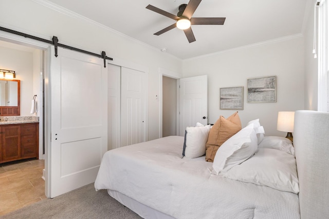 343 Rossford Ave, Fort Thomas, KY 41075 - bedroom featuring a barn door, ornamental molding, a closet, connected bathroom, and a ceiling fan