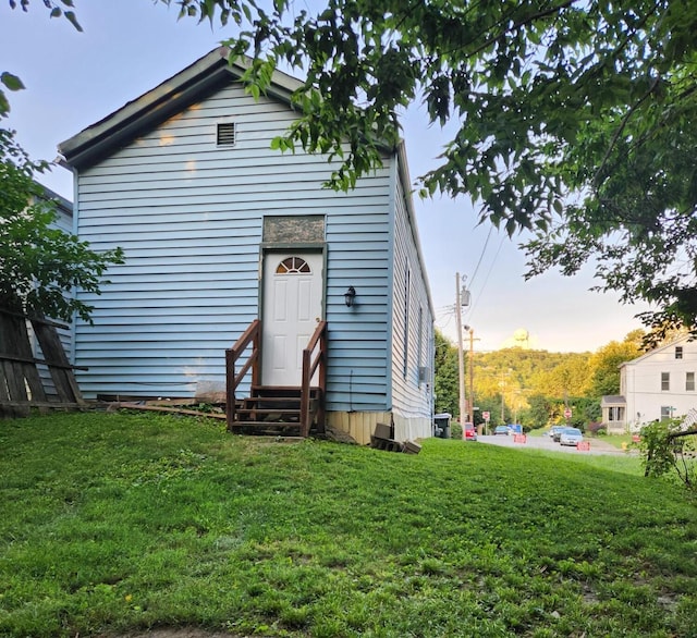 1539 Wheeler Aly, Covington, KY 41014 - back of property at dusk featuring entry steps and a lawn