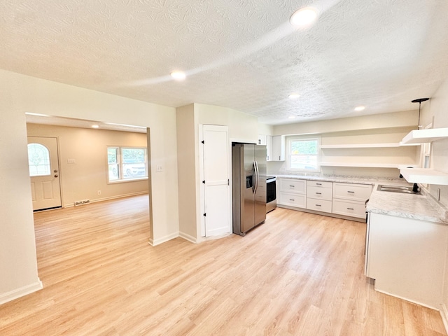 13165 Burns Rd, California, KY 41007 - kitchen featuring stainless steel refrigerator with ice dispenser, open shelves, light wood-type flooring, a textured ceiling, and white cabinetry