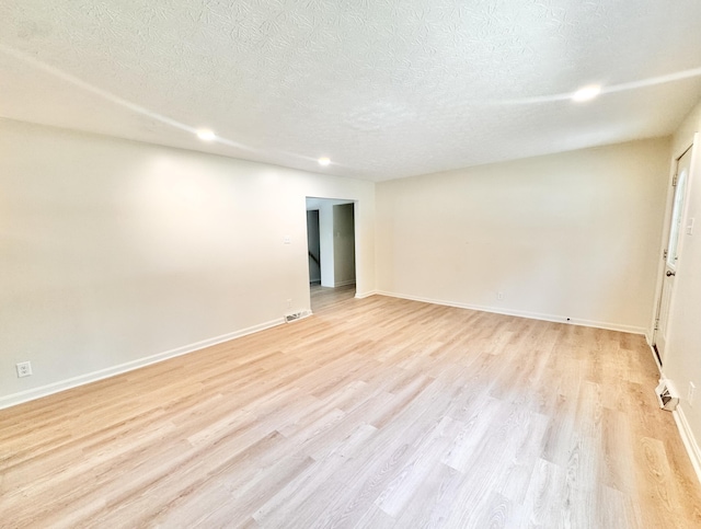 13165 Burns Rd, California, KY 41007 - unfurnished room with light wood-style floors, a textured ceiling, and recessed lighting