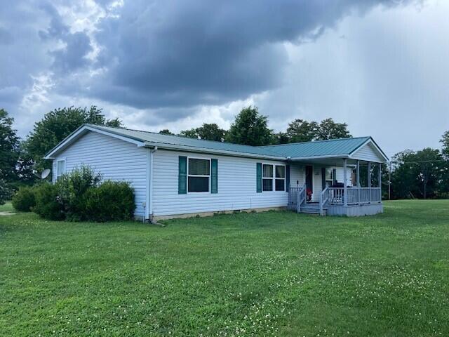2060 Augusta Minerva Rd, Augusta, KY 41002 - ranch-style house with a porch, a front yard, and a metal roof
