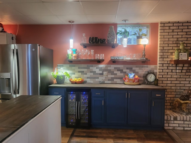 5809 Taylor Mill Rd, Covington, KY 41015 - indoor wet bar featuring stainless steel refrigerator with ice dispenser, wine cooler, dark wood finished floors, backsplash, and a paneled ceiling
