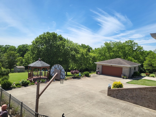 5809 Taylor Mill Rd, Covington, KY 41015 - view of patio / terrace featuring driveway, a gazebo, an attached garage, and view of wooded area