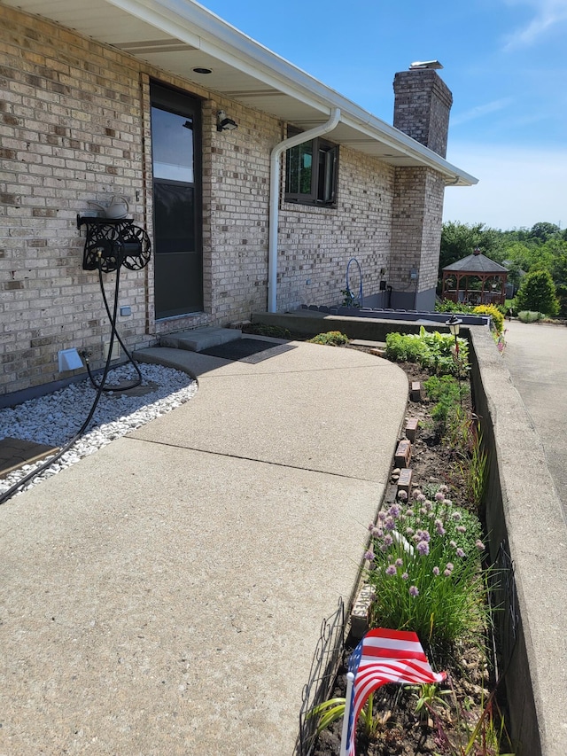 5809 Taylor Mill Rd, Covington, KY 41015 - view of exterior entry featuring a chimney and brick siding