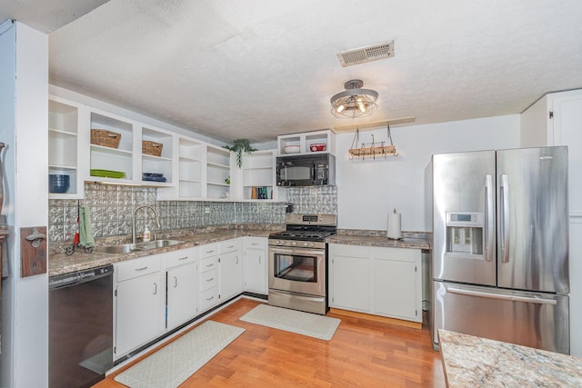 575 Sugar Creek Rd, Dry Ridge, KY 41035 - kitchen featuring black appliances, open shelves, light wood-style flooring, decorative backsplash, and a textured ceiling