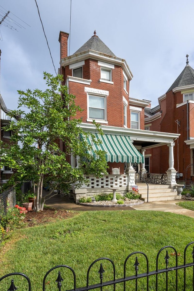 321 6th Ave, Dayton, KY 41074 - back of house featuring brick siding, a lawn, and a chimney