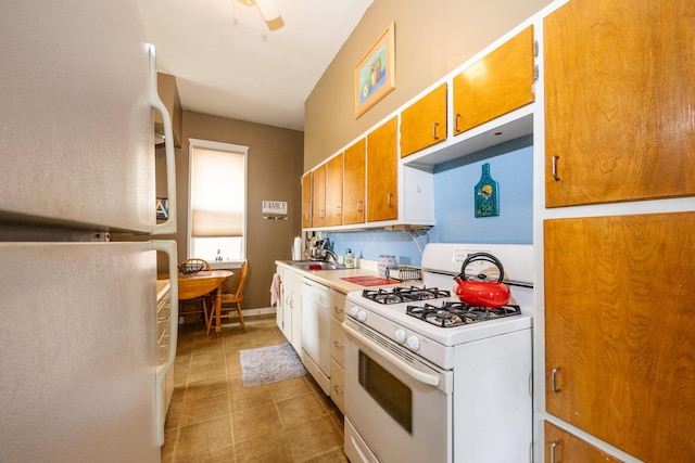 321 6th Ave, Dayton, KY 41074 - kitchen featuring white appliances, light countertops, brown cabinets, a ceiling fan, and light tile patterned floors
