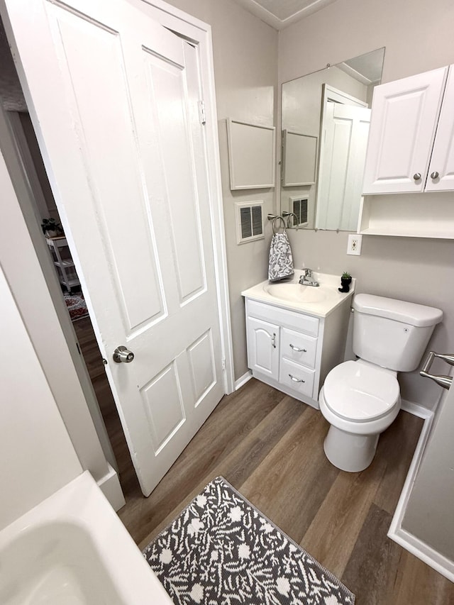 626 W 12th St, Covington, KY 41011 - bathroom featuring vanity, wood finished floors, and a bath