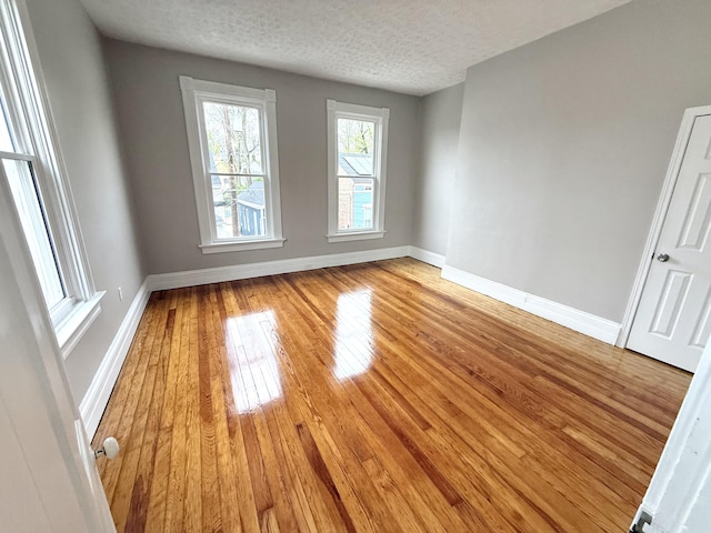 626 W 12th St, Covington, KY 41011 - spare room featuring light wood-style floors and a textured ceiling