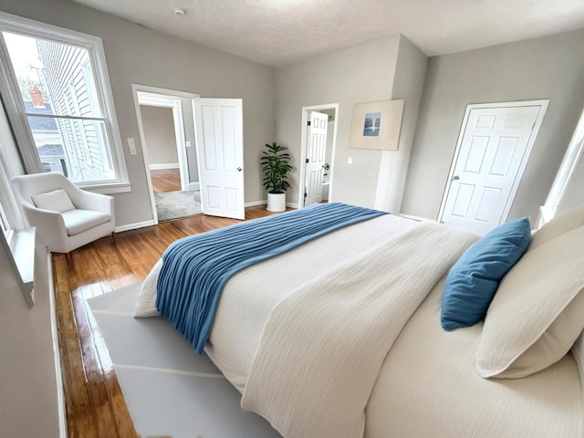 626 W 12th St, Covington, KY 41011 - bedroom featuring wood finished floors and baseboards
