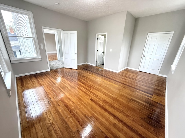 626 W 12th St, Covington, KY 41011 - unfurnished bedroom featuring hardwood / wood-style flooring and baseboards